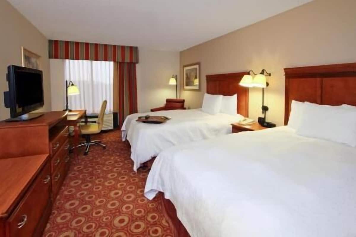 Hypo-allergenic bedding, desk, laptop workspace, blackout drapes