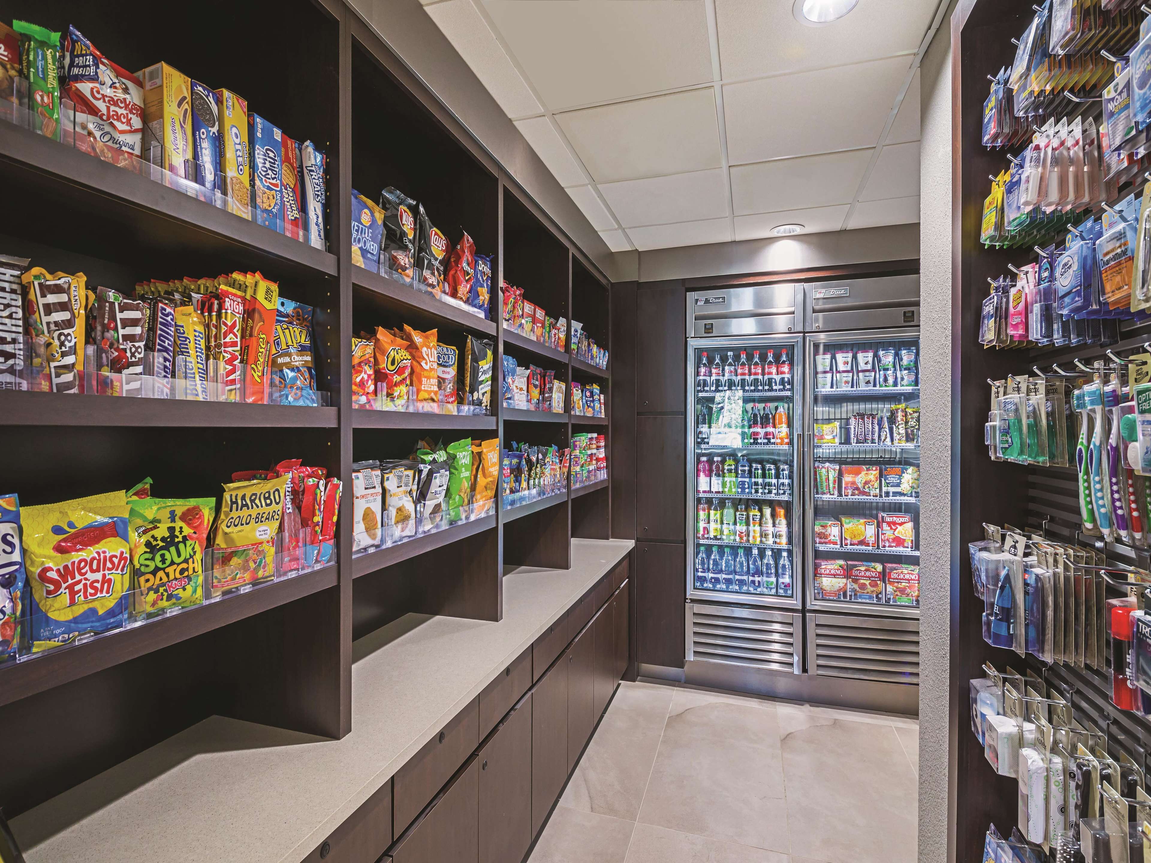 A grocery store with shelves stocked with snacks and beverages.