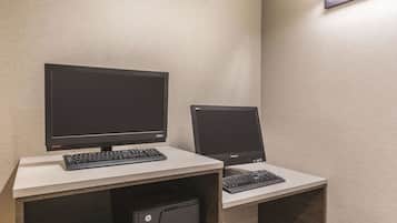 A workspace with two monitors, a keyboard, and an HP printer on a desk.