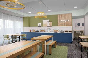 A modern cafe with wooden tables and benches, a blue counter with a 'Delight in the day' sign, and framed artwork on the walls. - Spark By Hilton San Antonio Northwest near Six Flags (San Antonio)