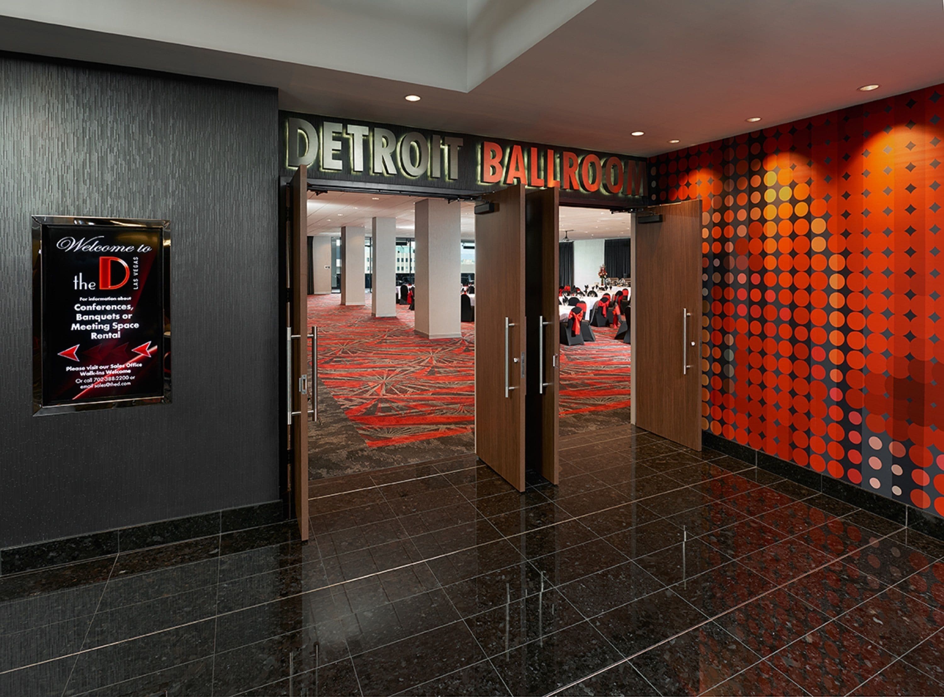 A hotel entrance with a sign for the Detroit Ballroom.