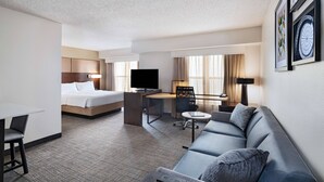 A hotel room with a bed, a desk, a sofa, and a TV. - Residence Inn by Marriott Austin The Domain Area (Austin)