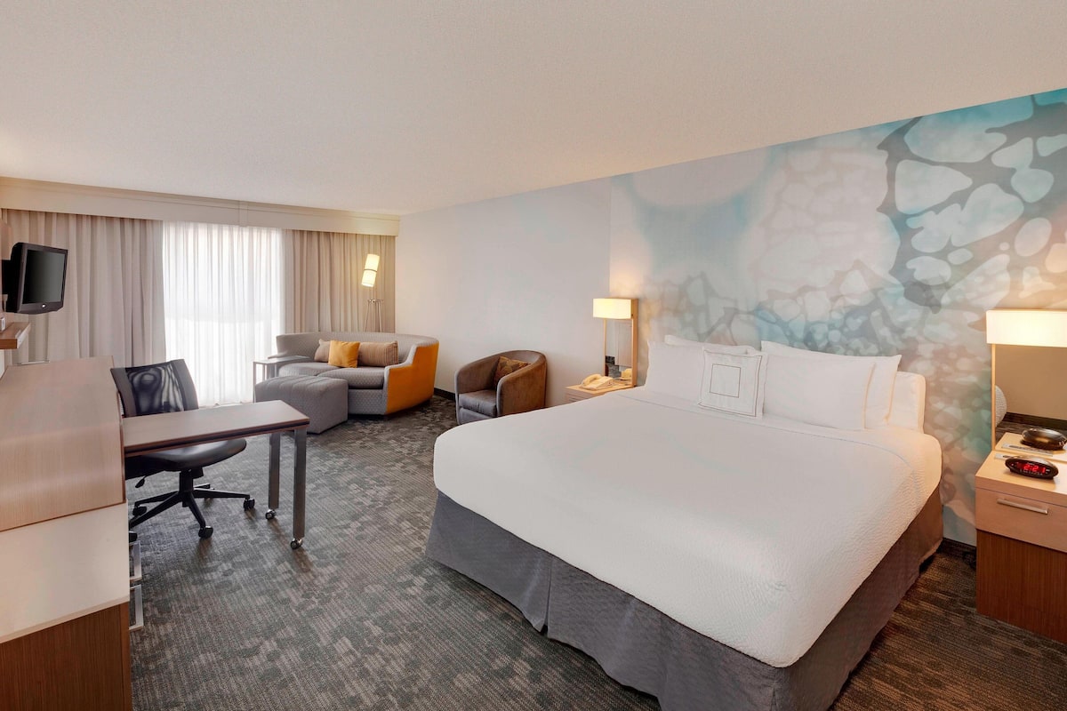 Premium bedding, desk, laptop workspace, iron/ironing board