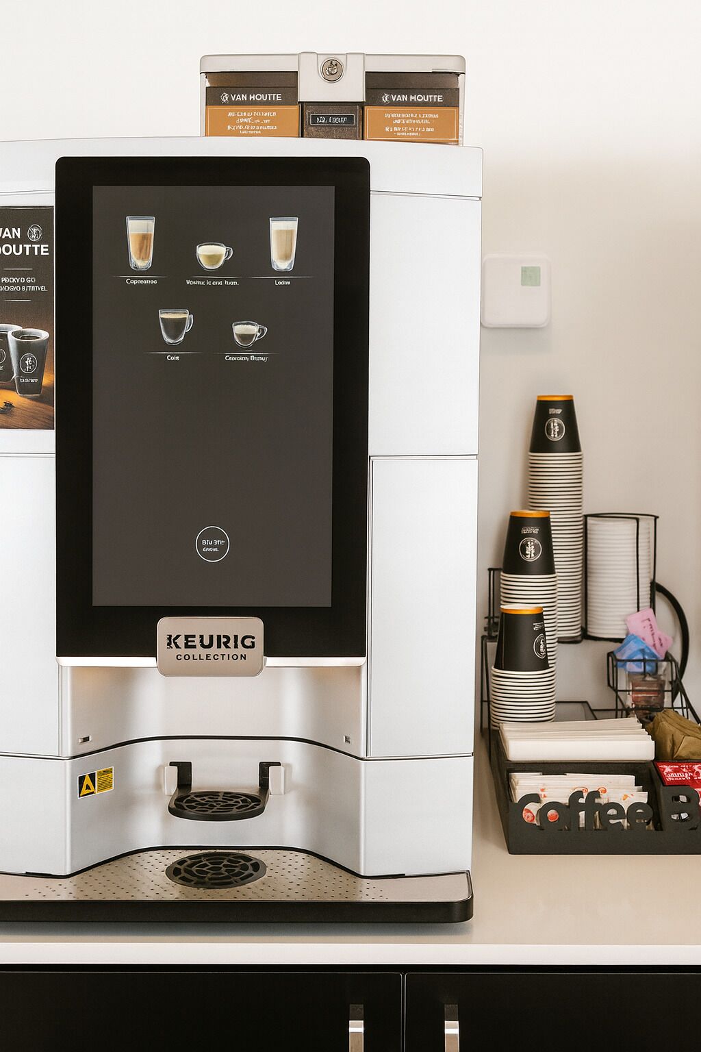 A Keurig coffee machine with a digital interface, coffee pods, and a coffee station with cups and a coffee machine.