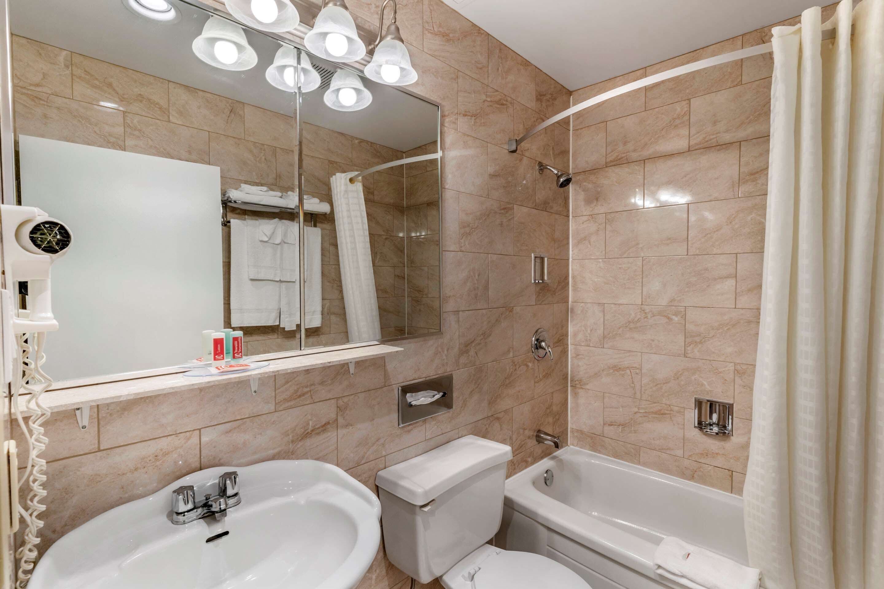 room, 2 queen beds, non smoking, jetted tub | bathroom | combined shower/bathtub, hair dryer, towels, soap