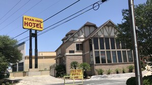 A Star Inn Hotel with a signboard, large windows, and a brick facade.