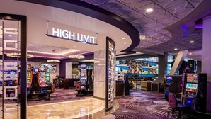 A casino area with multiple gaming machines, a 'HIGH LIMIT' sign, and a modern ceiling design. - Harrah’s Las Vegas – A Caesars Rewards Destination (Las Vegas)