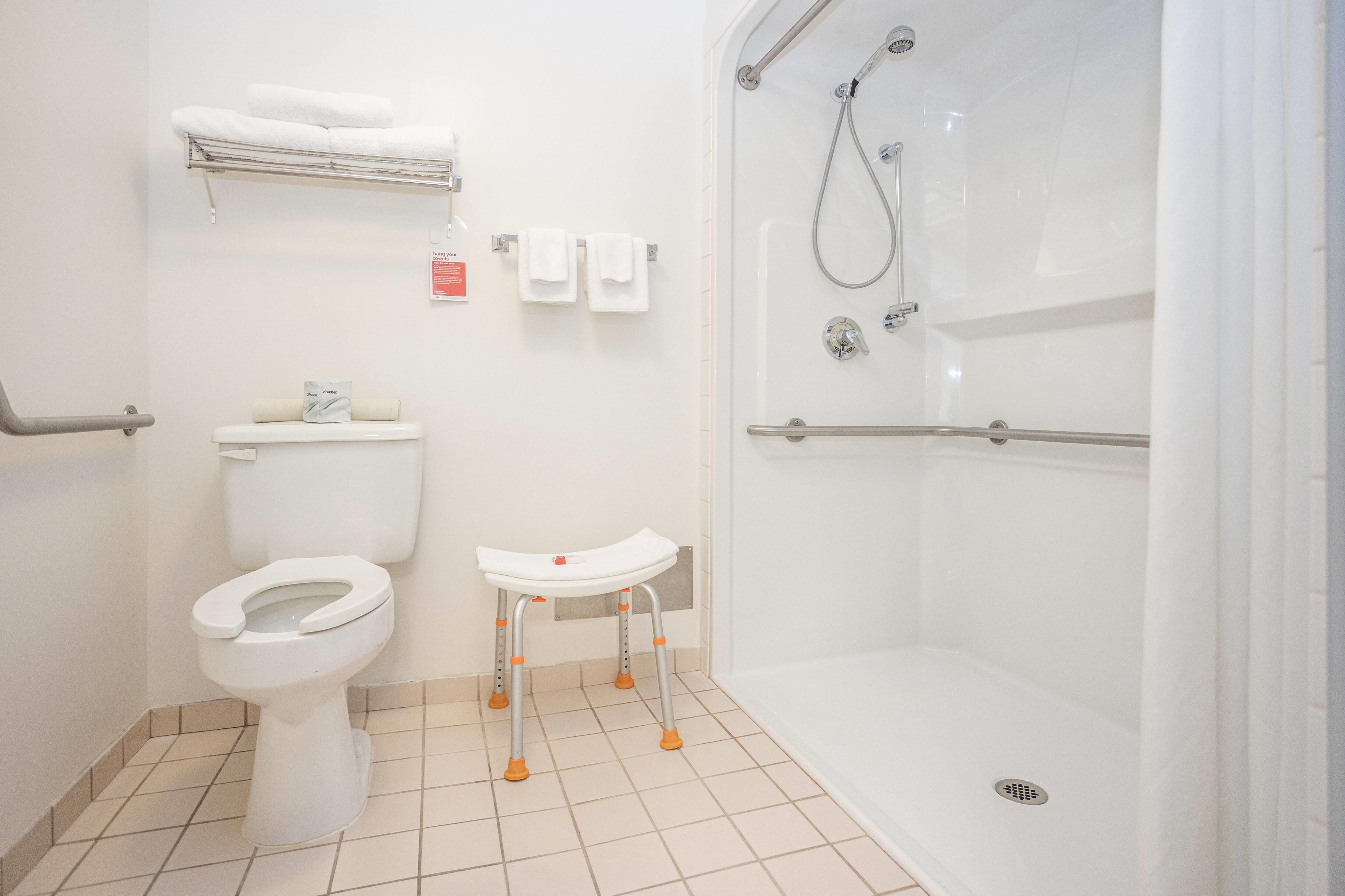 A bathroom with a toilet, sink, and shower.