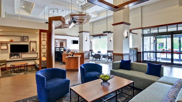 A spacious lobby with a seating area, a reception desk, and a large window offering a view of the outdoors. - Hyatt Place Memphis/Wolfchase Galleria (Memphis)