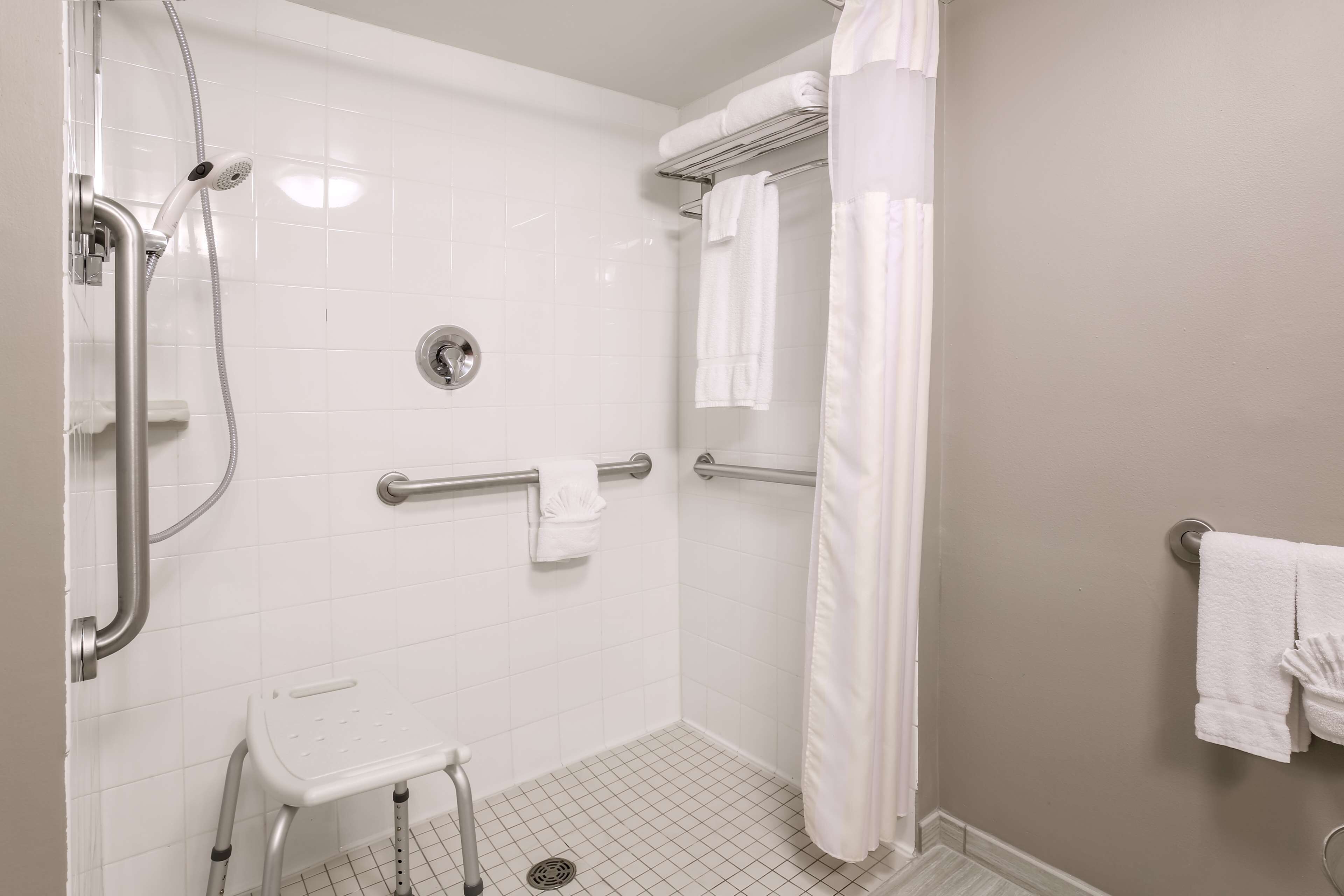 combined shower/bathtub, designer toiletries, hair dryer, towels