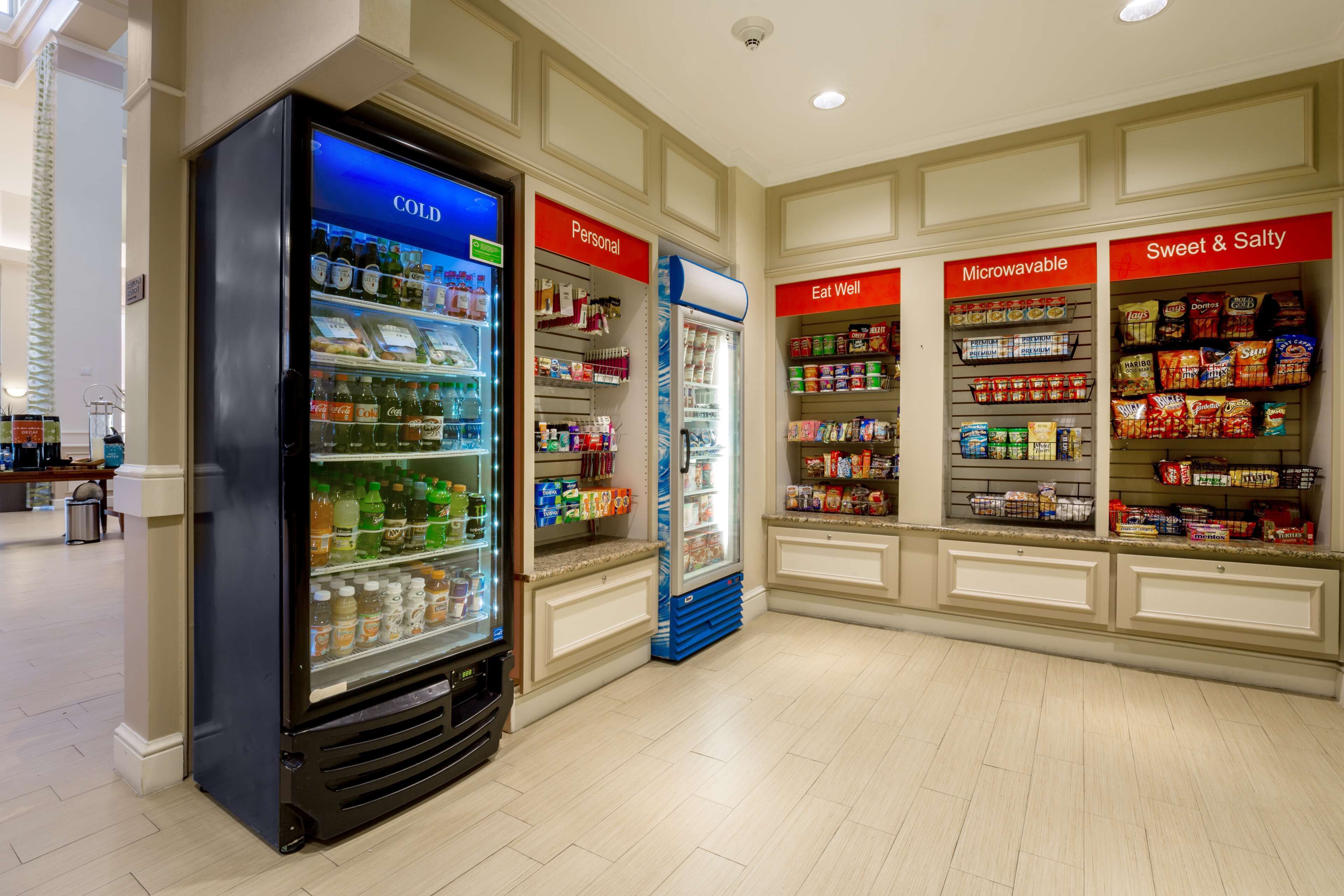 A refrigerated display area with sections labeled 'COLD', 'Personal', 'Eat Well', 'Microwavable', and 'Sweet & Salty'.