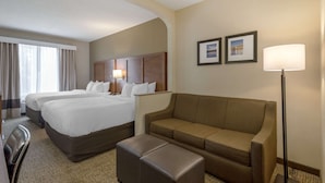 A hotel room with two beds, a sofa, a chair, and a desk. - Comfort Suites Columbus State University Area (Columbus)