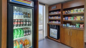 A vending machine with various beverages and a refrigerated display case. - Comfort Suites Columbus State University Area (Columbus)