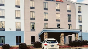 A Comfort Suites hotel with a modern facade, multiple windows, and a covered parking area. - Comfort Suites Columbus State University Area (Columbus)