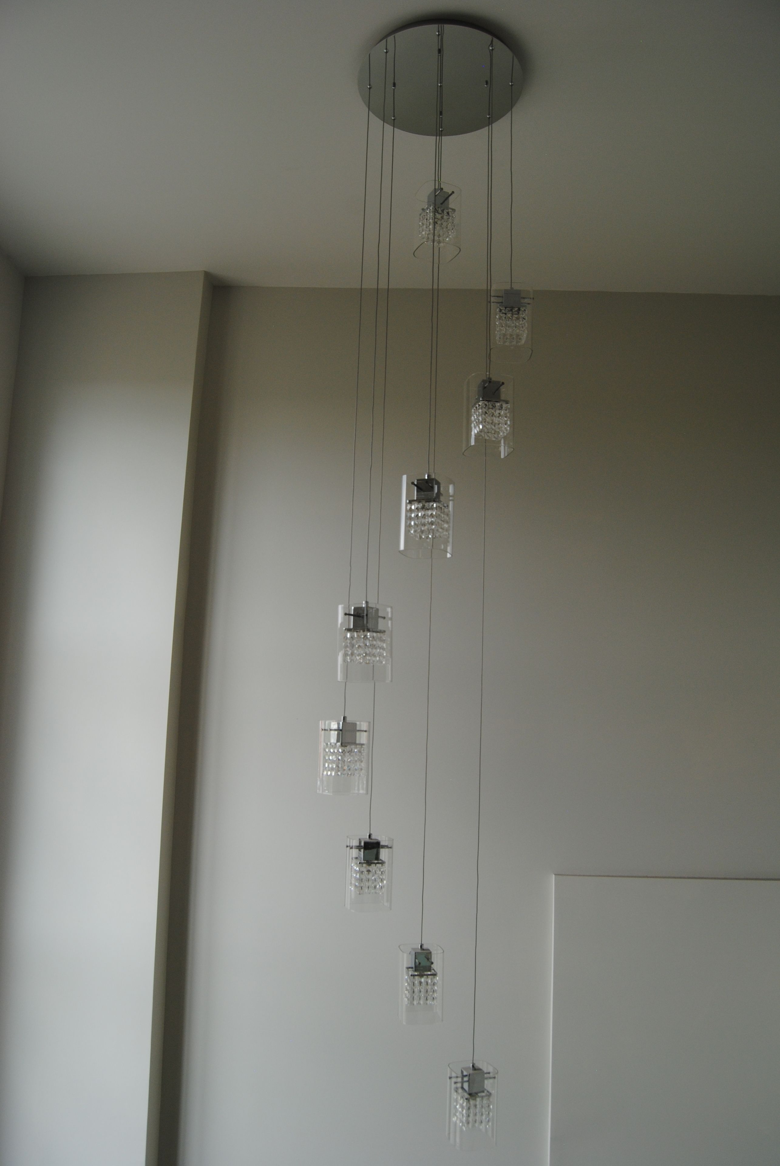 A modern chandelier with multiple clear glass shades hanging from a central point.