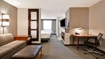 Premium bedding, desk, laptop workspace, blackout drapes