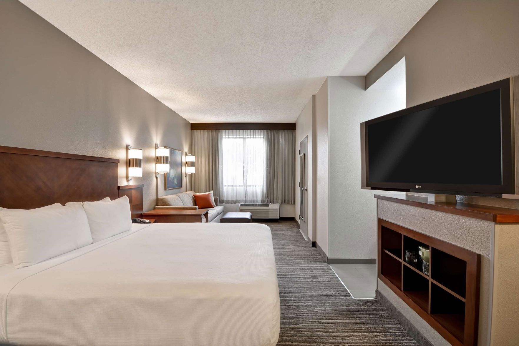 Premium bedding, desk, laptop workspace, blackout drapes
