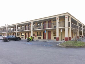 Ein mehrstöckiges Hotel mit Parkplatz.