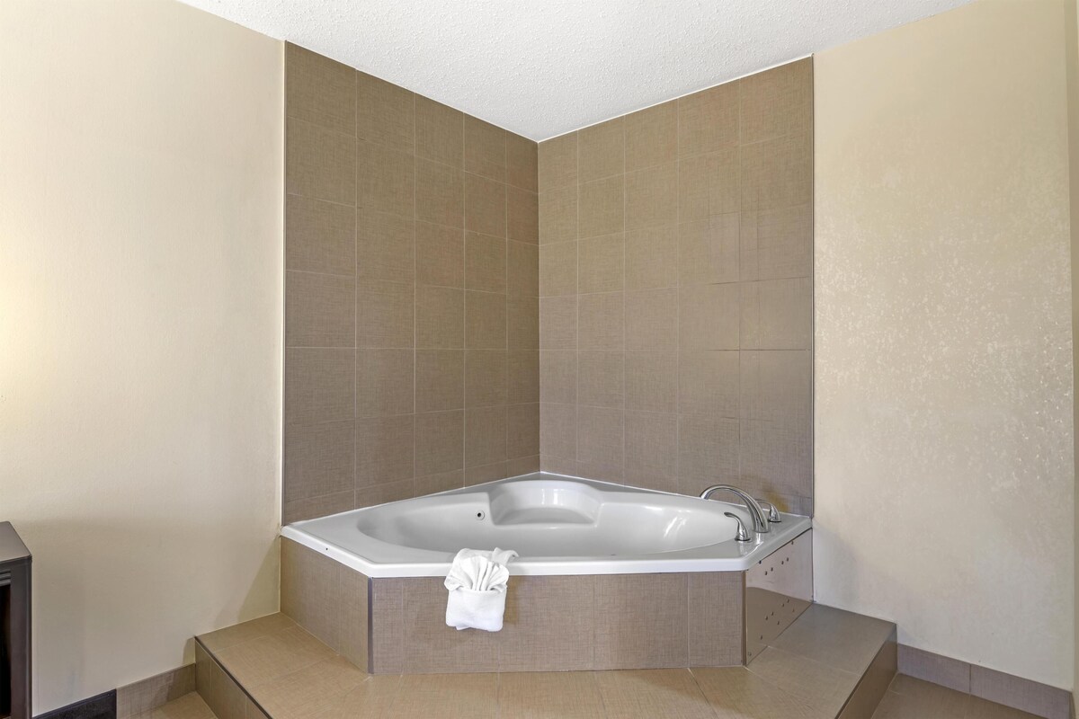 A modern bathroom with a freestanding bathtub, a built-in sink, and a towel rack.