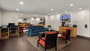 A modern hotel room with a living area, a kitchenette, a dining area, and a workspace. - Comfort Inn & Suites Austin North Loop (Austin)