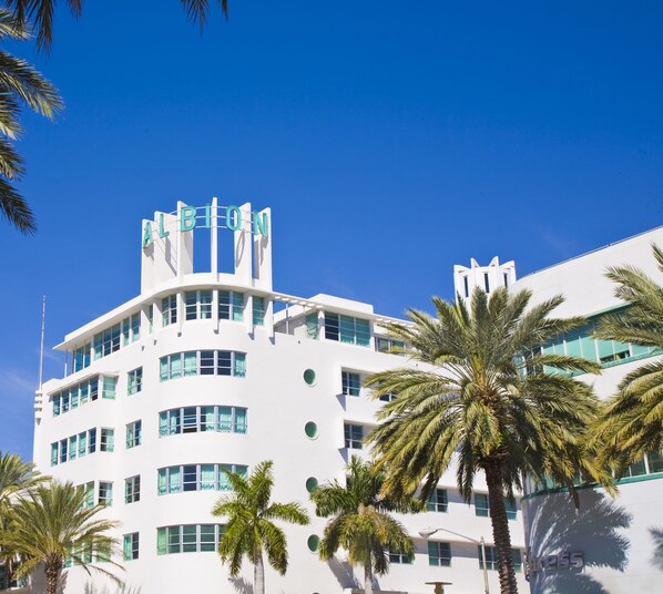 A modern building with a distinctive curved facade, multiple windows, and a prominent sign at the top.