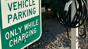 An electric vehicle charging station with a sign indicating it is for electric vehicle parking only while charging. - Red Roof Inn Tucson North - Marana (Tucson)