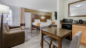 A hotel room with a bed, a desk, a chair, a lamp, a microwave, and a coffee maker. - Comfort Suites Tucson near Sabino Canyon (Tucson)