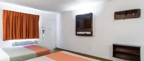 A hotel room with two beds, a television mounted on the wall, and a coat rack.