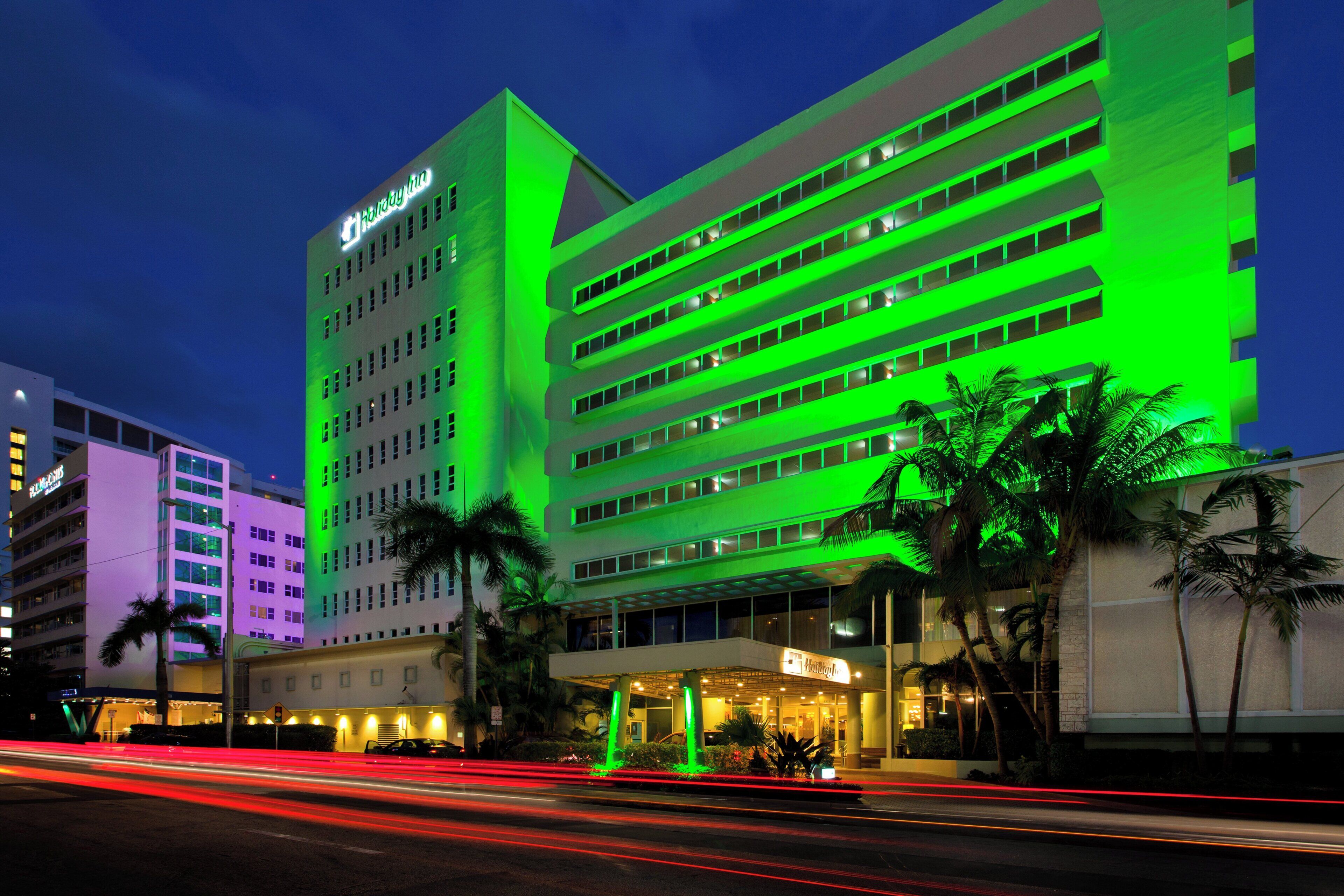 A multi-story hotel with a prominent sign at the top.