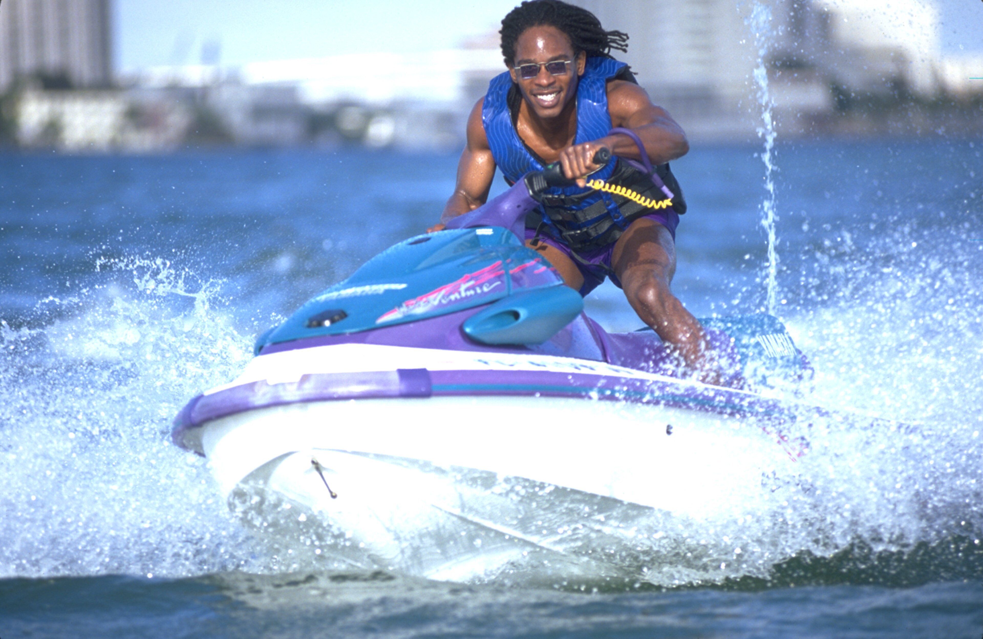 A person jet skiing on a watercraft.