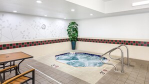 A hot tub area with a tiled floor, a wooden table with benches, a metal ladder, and a potted plant. - Sleep Inn Missoula Southgate (Missoula)