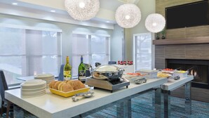 Un comedor moderno con barra de buffet, que incluye platos, tazones y botellas.