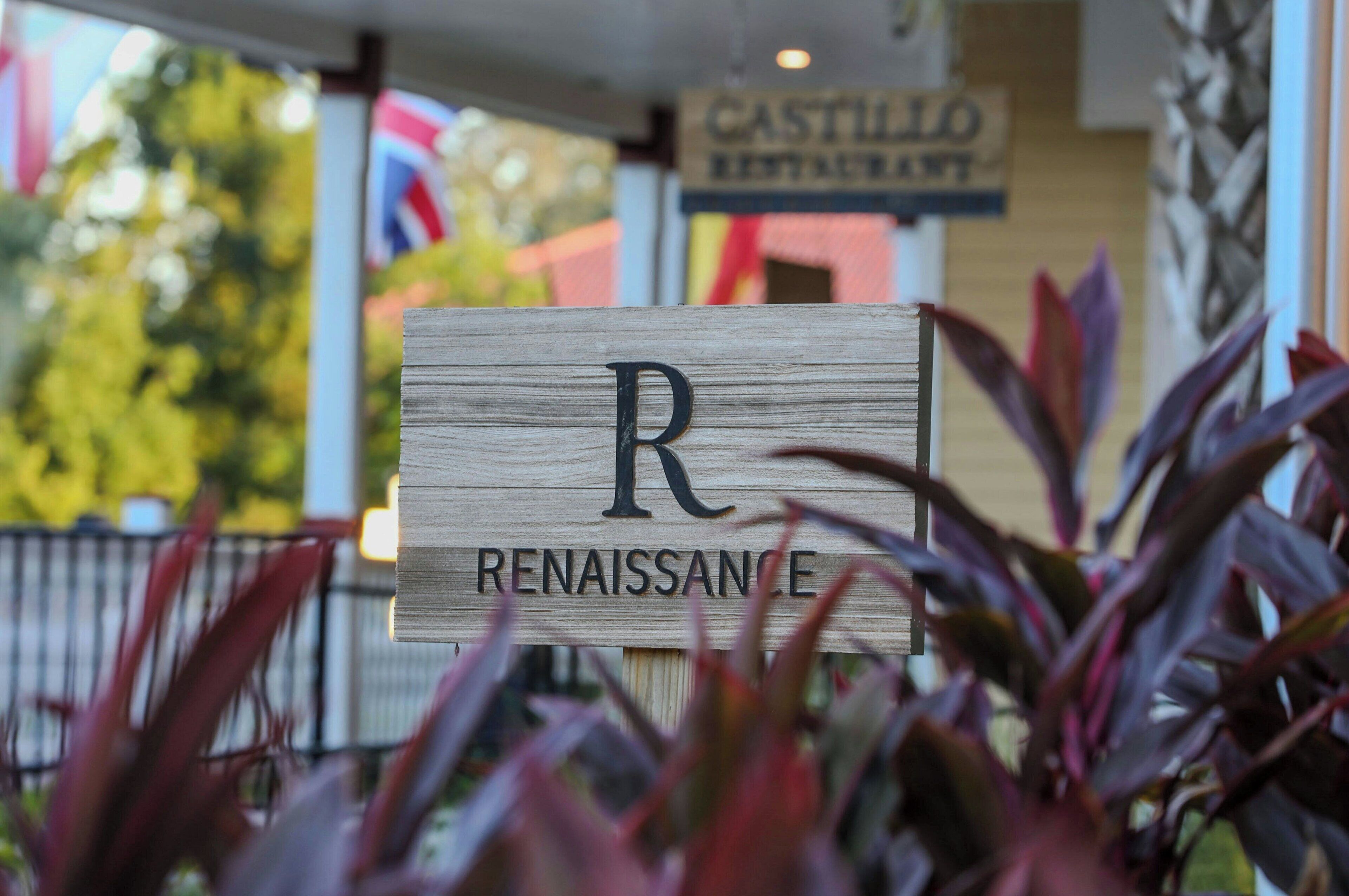 A wooden sign with the letter "R" and the word "RENAISSANCE" indicating a Renaissance-themed establishment.