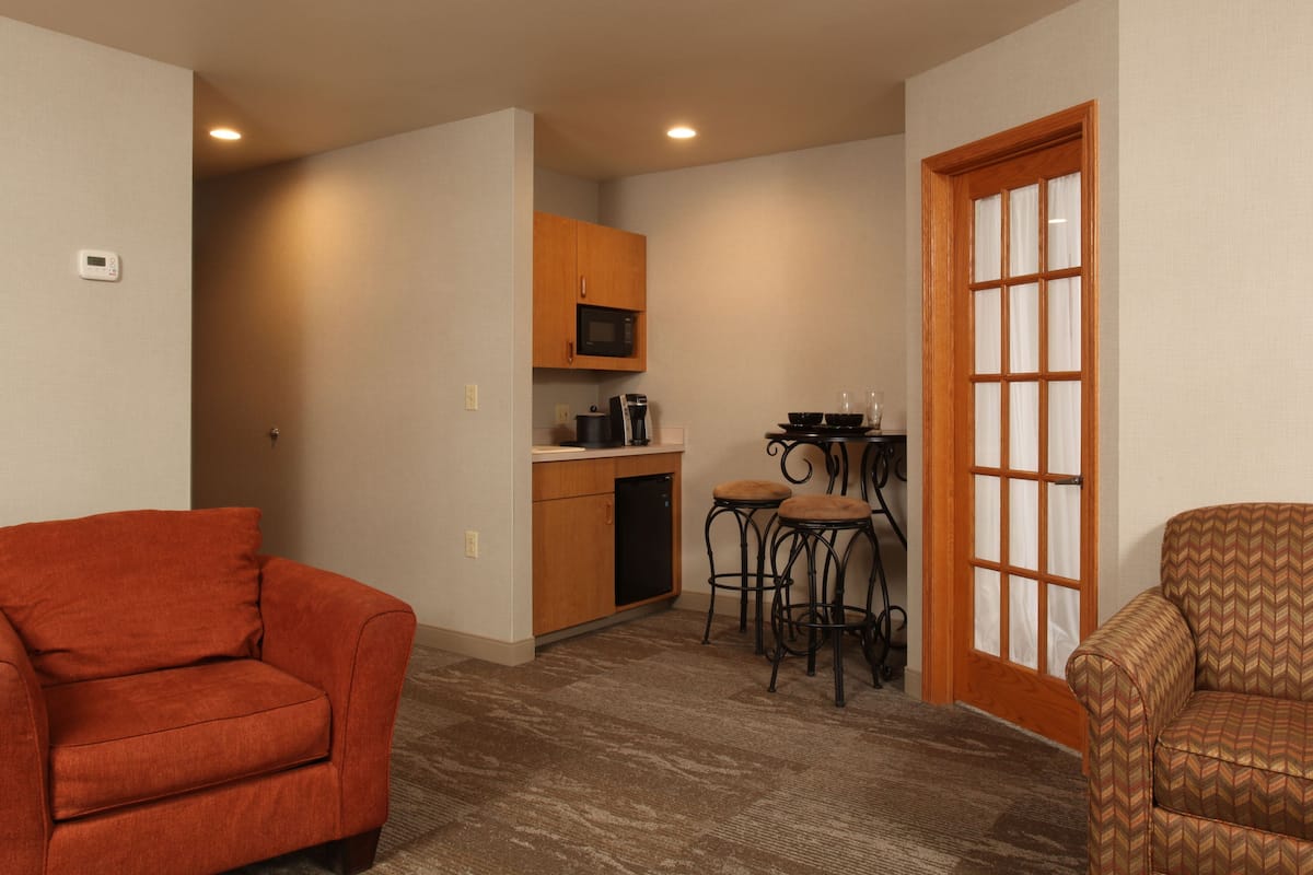 suite, 2 queen beds, non smoking, fireplace | living area | 49-inch flat-screen tv with digital channels, tv, ipod dock