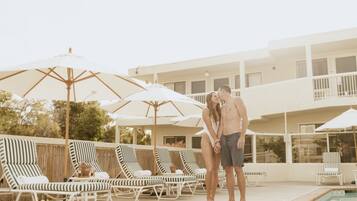 Piscine extérieure, parasols de plage, chaises longues