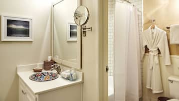A bathroom with a sink, mirror, towel rack, and a shower curtain.