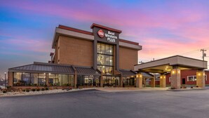 A Best Western Plus hotel with a modern brick facade, large glass windows, and a covered entrance area.