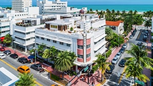 A hotel with a modern design, located at a street corner with a view of the beach.