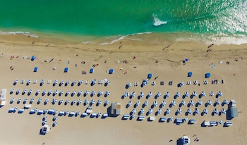 Beach nearby, white sand, sun loungers, beach towels at Dream South Beach, by Hyatt