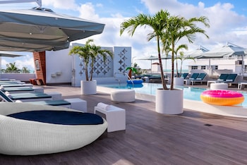 Outdoor pool, open 9:00 AM to 7:00 PM, pool umbrellas, sun loungers at Dream South Beach, by Hyatt