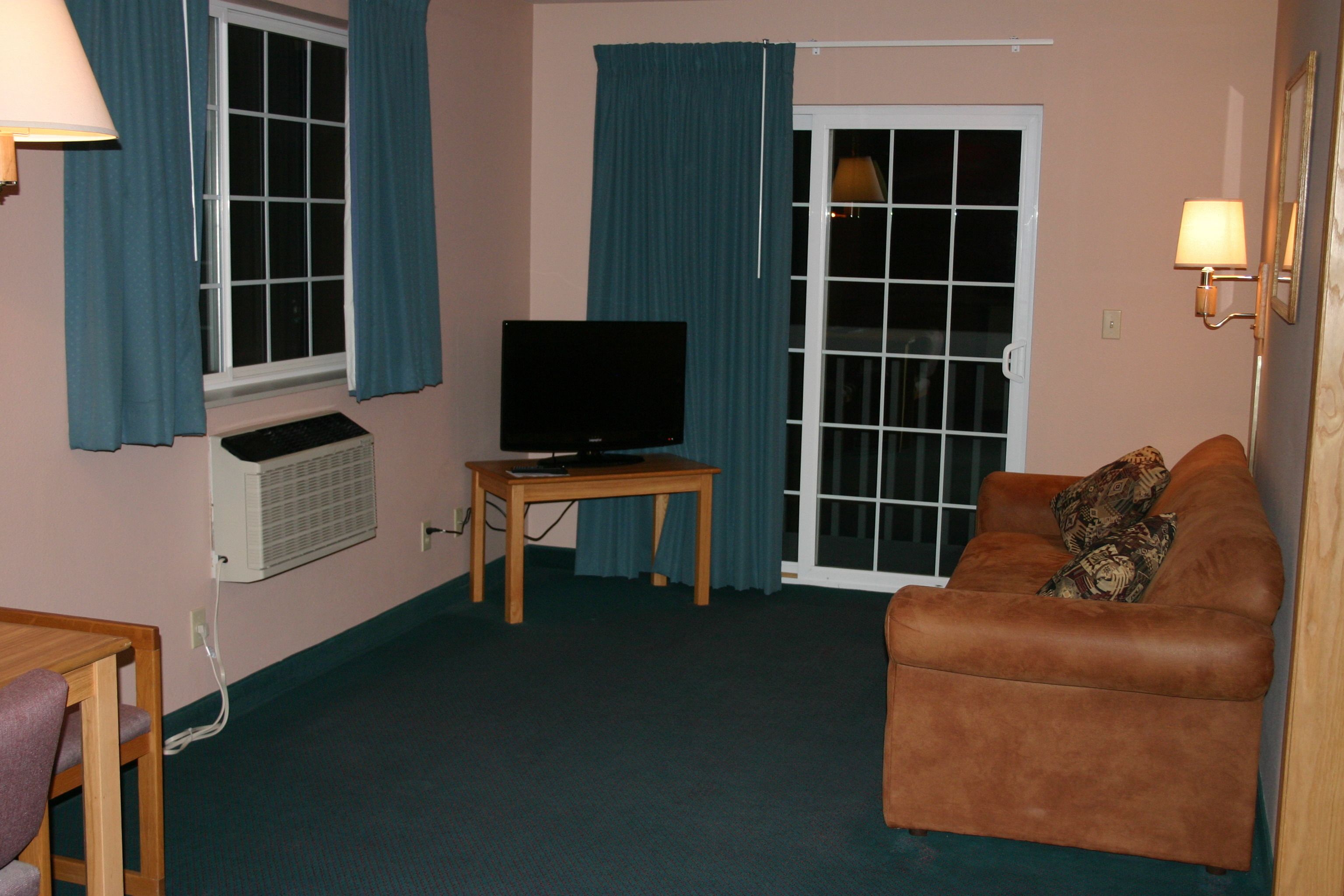 standard king suite, sofa sleeper | living area | 30-inch flat-screen tv with satellite channels, tv