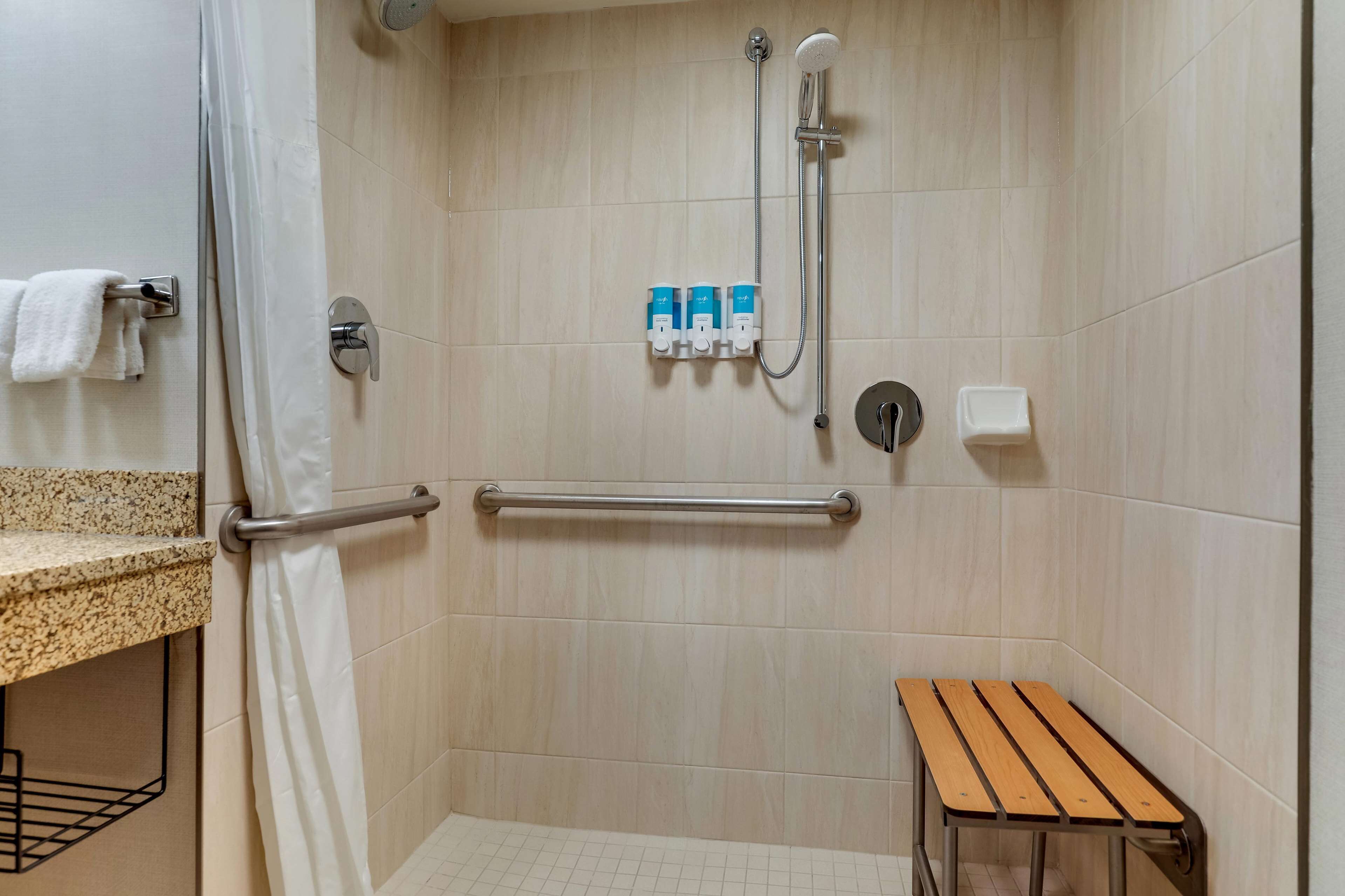 deluxe room, 1 king bed, accessible, refrigerator & microwave (roll in shower) | bathroom | combined shower/bathtub, free toiletries, hair dryer, towels