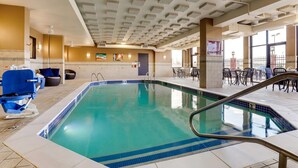 An indoor swimming pool with clear blue water, a tiled floor, and a ceiling with square vents. - Drury Inn & Suites St. Louis St. Peters (St. Peters)
