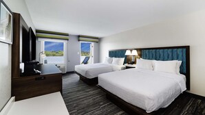 A hotel room with two beds, a desk, a TV, and a window with a view of the outdoors. - Hampton Inn Port Charlotte (Port Charlotte)