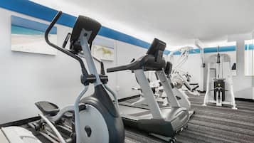 A gym with stationary bikes, treadmills, and weight machines.