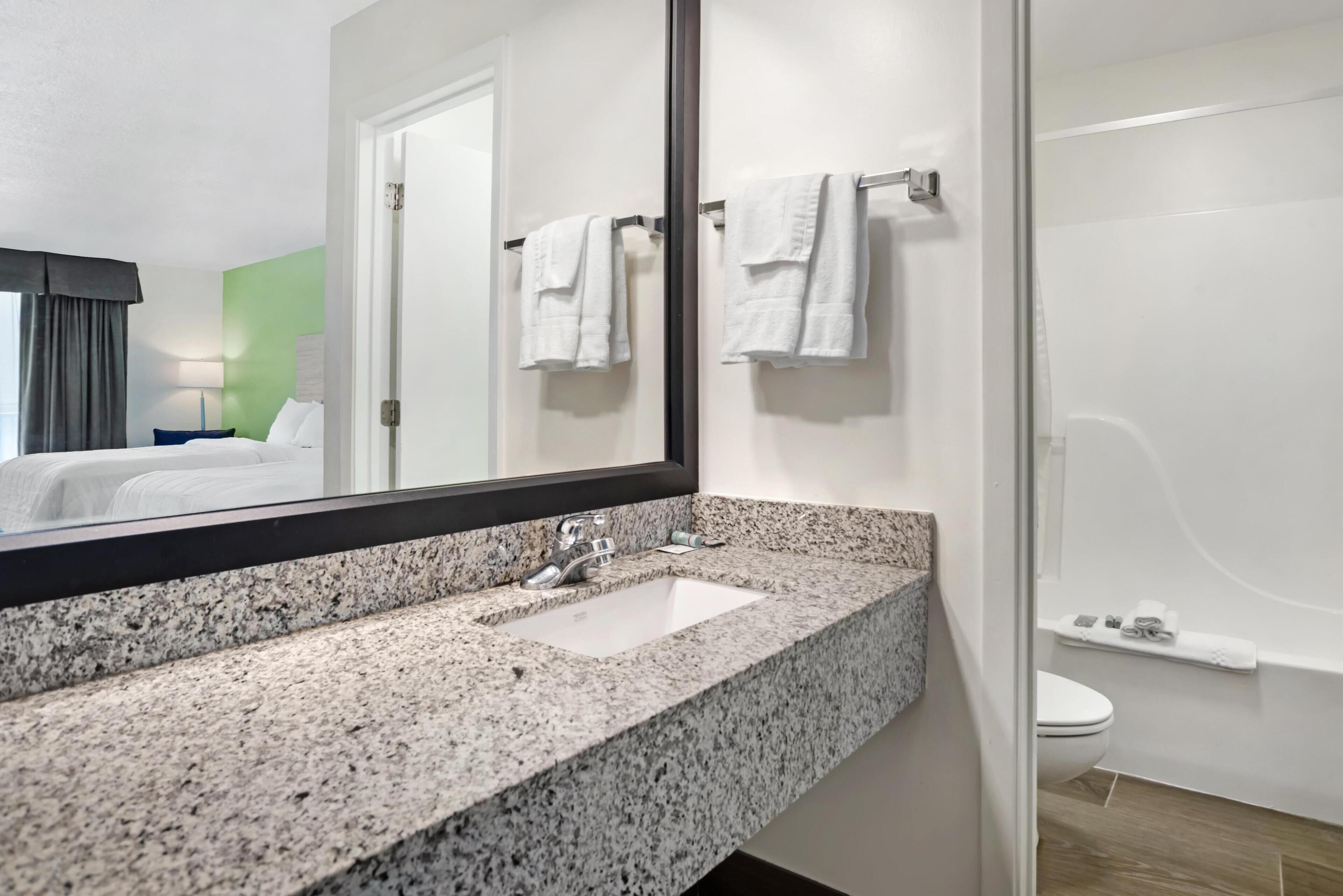 standard room, 2 queen beds, microwave, pool view | bathroom | combined shower/bathtub, free toiletries, hair dryer, towels