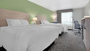 A hotel room with two beds, a desk, and a chair. - Best Western Navarre Waterfront (Navarre)