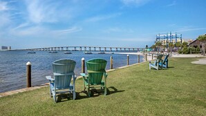 A waterfront view with chairs and a pier in the background. - Best Western Navarre Waterfront (Navarre)