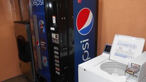 A vending machine with a Pepsi logo and a water dispenser with instructions.