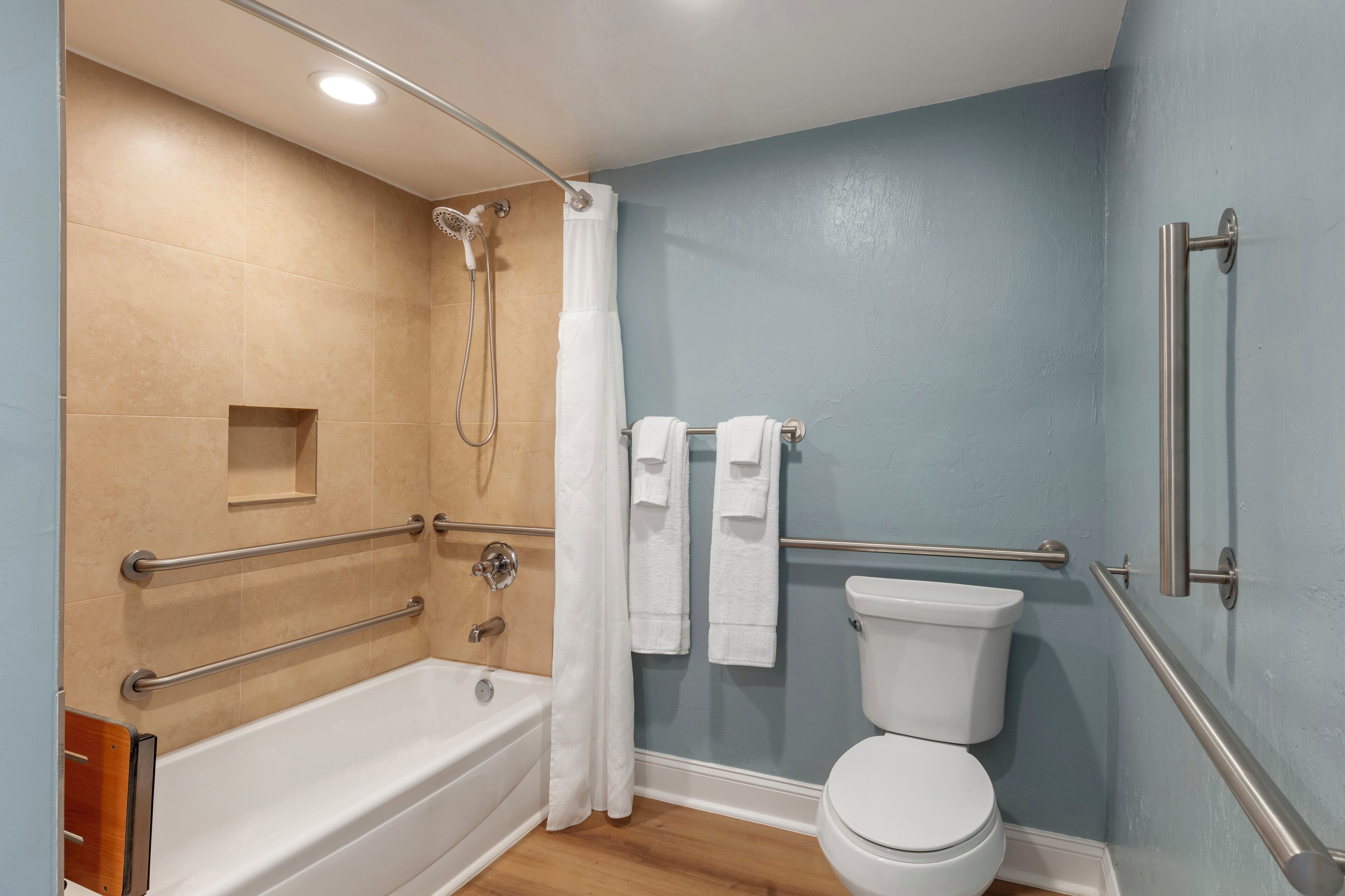 A bathroom with a bathtub, toilet, and shower.